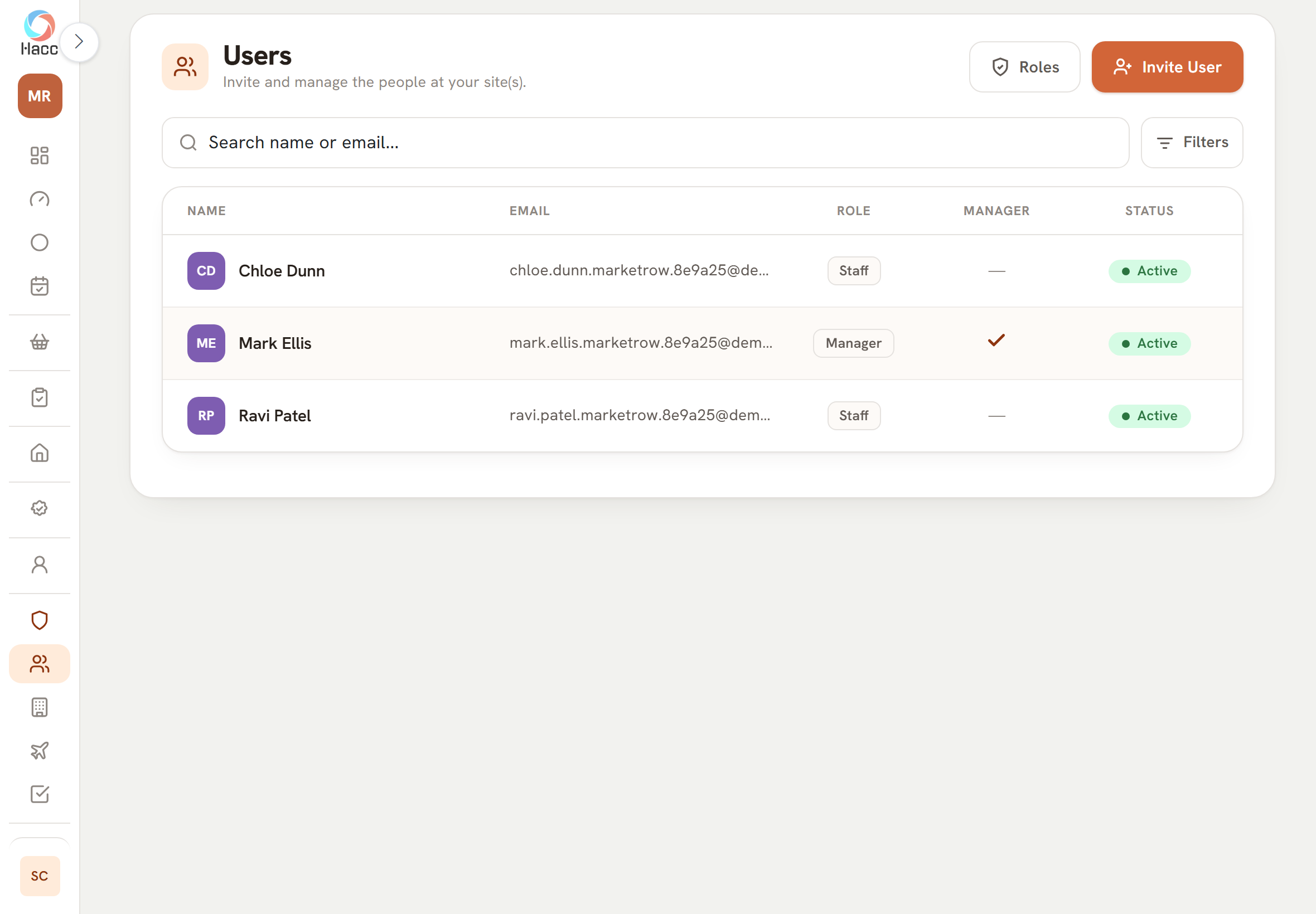 The Users page on a tablet, with the line "Invite and manage the people at your site(s)." under the heading and two buttons at the top right, "Roles" and "Invite User". Below a "Search name or email..." box and a Filters button is a table with the columns Name, Email, Role, Manager and Status. It lists three people: two with the role "Staff", and one with the role "Manager" and a tick in the Manager column. All three are "Active". The email addresses are cut short.